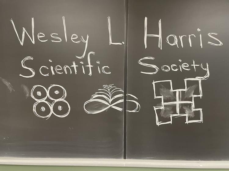 Wesley L. Harris Scientific Society name written on a chalk board.